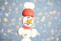 Funny snowman made of marshmallows against blurred festive lights, closeup. Space for text Royalty Free Stock Photo