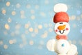 Funny snowman made of marshmallows against blurred festive lights, closeup. Space for text Royalty Free Stock Photo