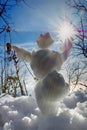 funny snowman in rays of sun Royalty Free Stock Photo