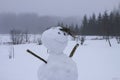 Funny snowman on snow covered rural field Royalty Free Stock Photo