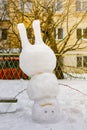 Funny snowman standing on his head