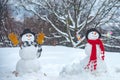 Funny snowmen. Winter scene with snowman on white snow background. I love you. Enjoying nice weekend together.