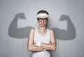 Funny sport nerd with shadow muscle arms Royalty Free Stock Photo