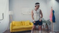 funny sportsman exercising with dumbbells in