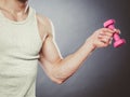 Funny sporty fit man lifting light dumbbell. Fun. Royalty Free Stock Photo