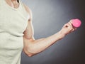 Funny sporty fit man lifting light dumbbell. Fun. Royalty Free Stock Photo