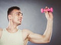 Funny sporty fit man lifting light dumbbell. Fun. Royalty Free Stock Photo