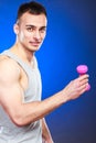 Funny sporty fit man lifting light dumbbell. Fun. Royalty Free Stock Photo