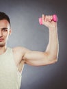 Funny sporty fit man lifting light dumbbell. Fun. Royalty Free Stock Photo