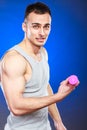 Funny sporty fit man lifting light dumbbell. Fun. Royalty Free Stock Photo