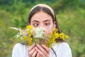 Funny spring young woman outdoor. Beautiful teen girl in a field of white flowers. Fun face emotions. Girl with a