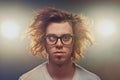 Funny Squinting man with Tousled brown hair in studio