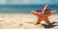 Funny starfish with red sunglasses at sand beach with copy space Royalty Free Stock Photo