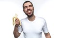 Funny and strange man is eating banana. He is enjoying that. Man is eating banana in a funny manner. His behave is like