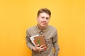 Funny student in glasses,shirt and with books and exercise books in hands, surprised looking at the camera. Surprised nerd stands Royalty Free Stock Photo