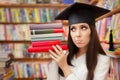 Funny Student with Graduation Cap Holding Books Royalty Free Stock Photo