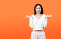 Funny stupid facial expression. Concept with brunette woman on orange background with copy space