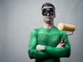 Funny superhero with painting roller