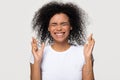 Funny superstitious black woman crossing fingers wishing for good luck Royalty Free Stock Photo