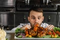 Funny surprised chef-cooker in kitchen