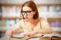 Funny surprised girl with glasses reading books Royalty Free Stock Photo