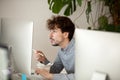 Funny surprised employee eating chinese food looking at computer