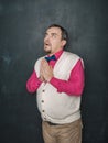 Funny teacher or business man pray on blackboard Royalty Free Stock Photo