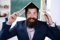 Funny teacher with laptop notebook in classroom at school. Excited teacher professor with laptop on head wearing formal Royalty Free Stock Photo