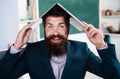 Funny teacher with laptop notebook in classroom at school. Excited teacher professor with laptop on head wearing formal Royalty Free Stock Photo