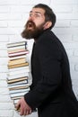 Funny teacher or professor with book stack. Thinking serious mature teacher. Falling books concept. Mature professor