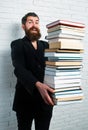 Funny teacher or professor with book stack. Thinking serious mature teacher. Falling books concept. Mature professor