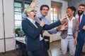 Teambuilding indoors activity. Business people making team training exercise during team building seminar singing karaoke Royalty Free Stock Photo