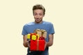 Funny teen boy offering gift boxes.