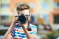 Funny teen boy with digital photo camera