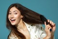 Funny teen girl bombs her hair in the morning. Over blue Royalty Free Stock Photo