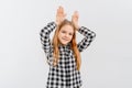 Funny teen girl standing over white background doing bunny ears gesture with hands palms looking happy and glad. Easter rabbit Royalty Free Stock Photo