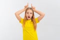 Funny teen girl standing over white background making horns on top of head with index fingers and smiling. Halloween concept. Cute Royalty Free Stock Photo