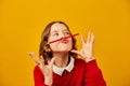 Funny teen school girl make mustache on her face with red pencil, Royalty Free Stock Photo