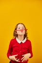 Funny teen school girl make mustache on her face with red pencil, Royalty Free Stock Photo