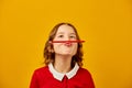 Funny teen school girl make mustache on her face with red pencil, Royalty Free Stock Photo