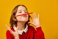 Funny teen school girl make mustache on her face with red pencil, Royalty Free Stock Photo