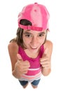 Funny teenage girl wearing a baseball cap doing a thumbs up sign Royalty Free Stock Photo