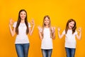 Funny three sister ladies holding hands in okey symbols wear casual outfit isolated yellow background Royalty Free Stock Photo