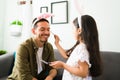 Funny time. Kid applying makeup to her dad Royalty Free Stock Photo