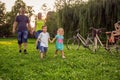 Funny time -young couple with their children have fun at beautiful park outdoor in nature Royalty Free Stock Photo