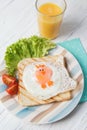 Funny toast with fried eggs in a shape of chicken and orange juice, healthy food for kids Easter idea