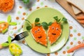 Funny toasts in a shape of carrots, food for kids Easter idea, top view