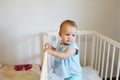 Funny toddler baby girl standing in her white bed Royalty Free Stock Photo