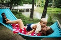 Young mother and little son in the park in the spring at sunset. Happy family. Weekend playtime concept Royalty Free Stock Photo