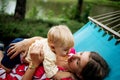 Young mother and little son in the park in the spring at sunset. Happy family. Weekend playtime concept Royalty Free Stock Photo